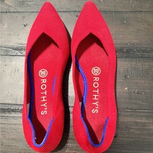 Rothy's Vibrant Red Flats with Blue Accents. The original Point.